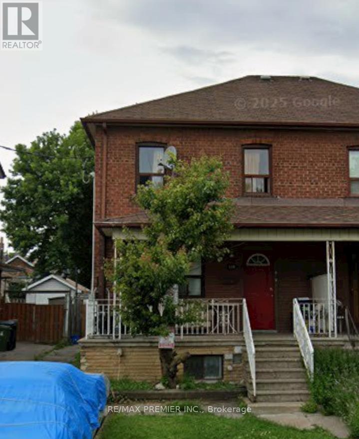 A house with a red door and a blue tarp in front.