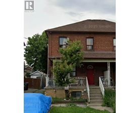 A house with a red door and a blue tarp in front.