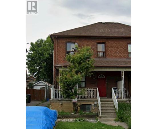 A house with a red door and a blue tarp in front.