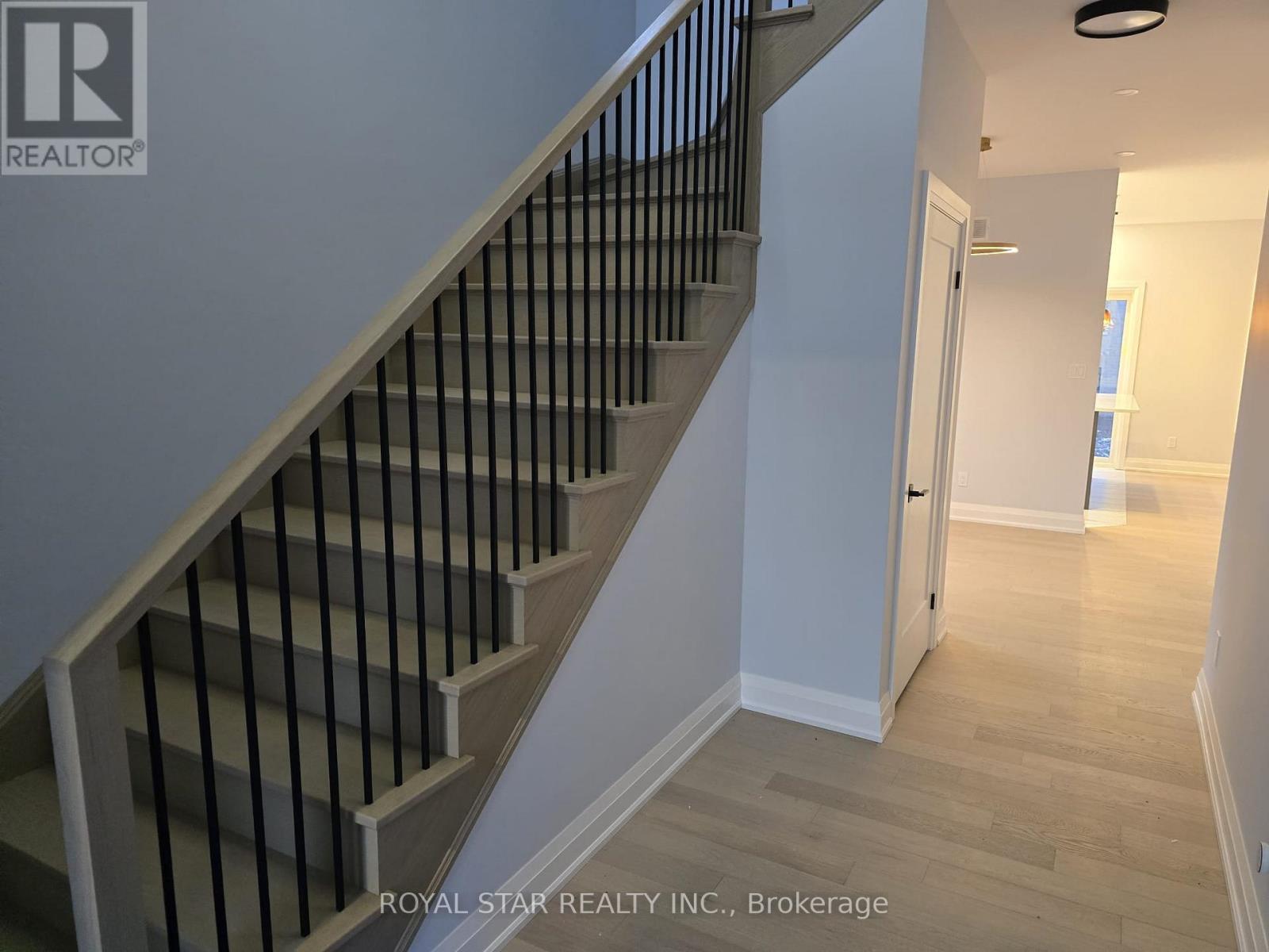 A staircase with a metal railing and wooden steps.