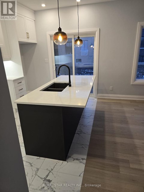A kitchen with a black and white counter top.