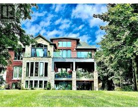 A large, multi-level house with a balcony and a large front yard.
