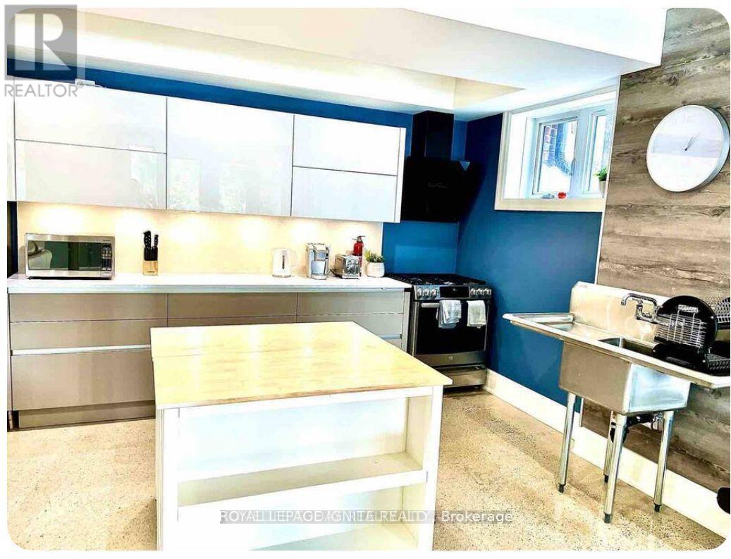 A kitchen with blue walls and a wooden counter.