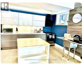 A kitchen with blue walls and a wooden counter.