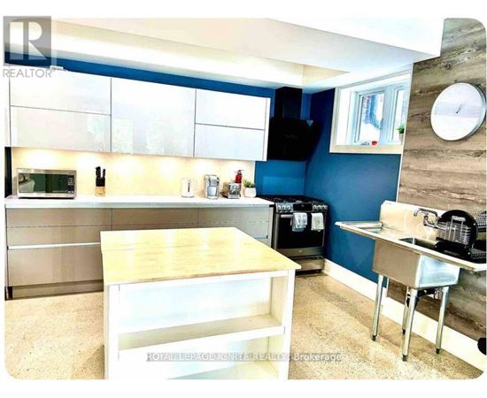 A kitchen with blue walls and a wooden counter.