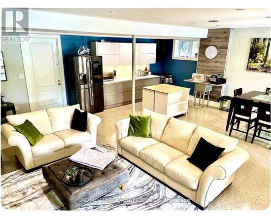 A living room with a white couch and a coffee table.