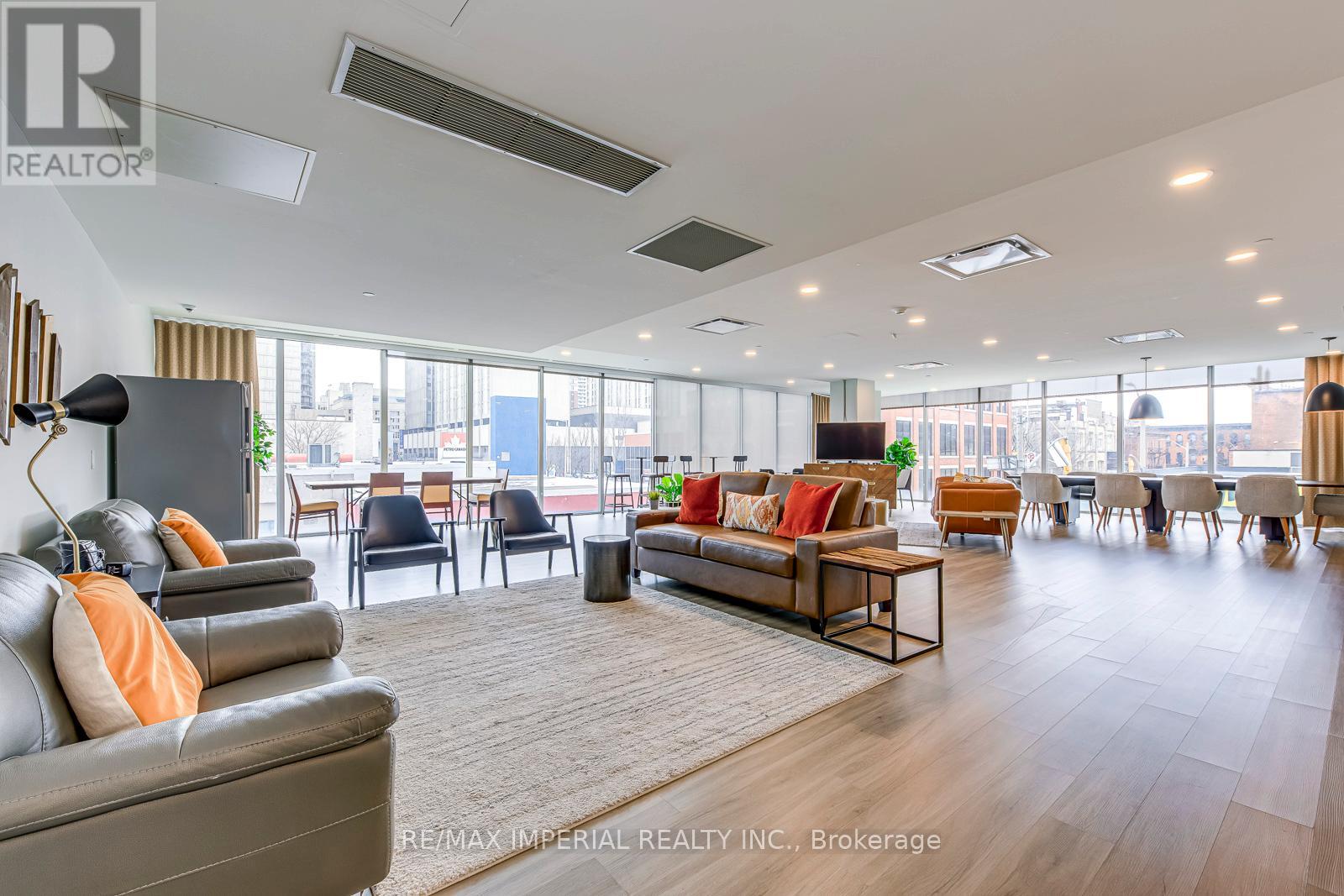 A spacious living room with a grey sofa and a wooden coffee table.