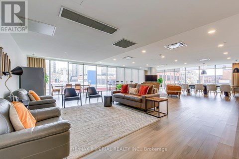A spacious living room with a grey sofa and a wooden coffee table.