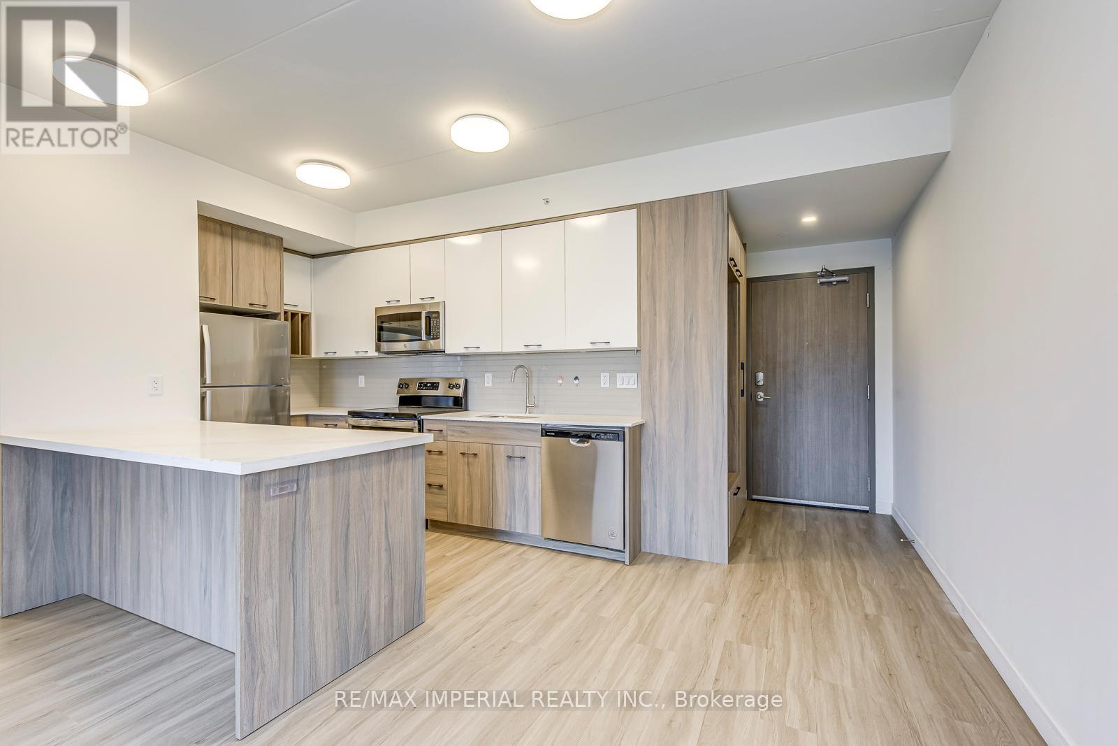 A modern kitchen with white cabinets and a wooden island.