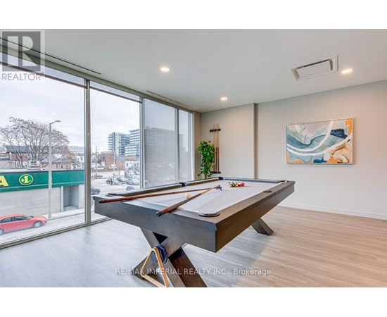 A pool table in a room with a view of a street outside.