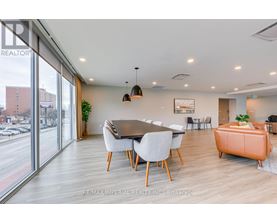 A modern dining room with a large table and chairs.