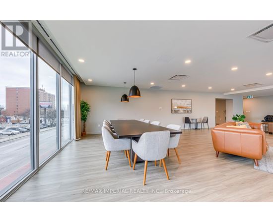 A modern dining room with a large table and chairs.