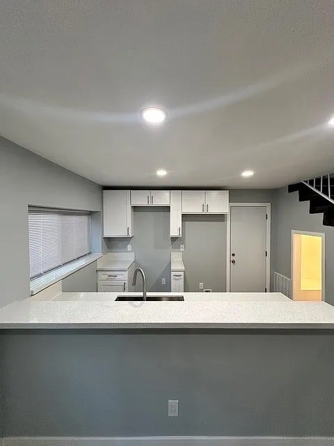 A kitchen with a sink and a window.