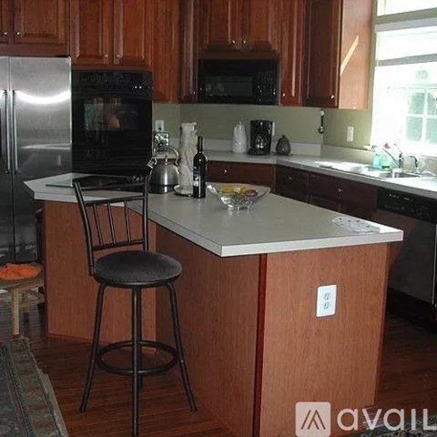 A kitchen with wooden cabinets and a white countertop.