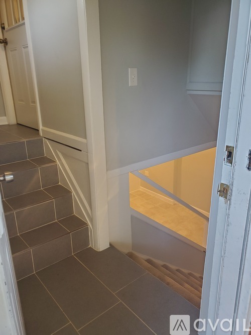 A stairway with a white door on the right.