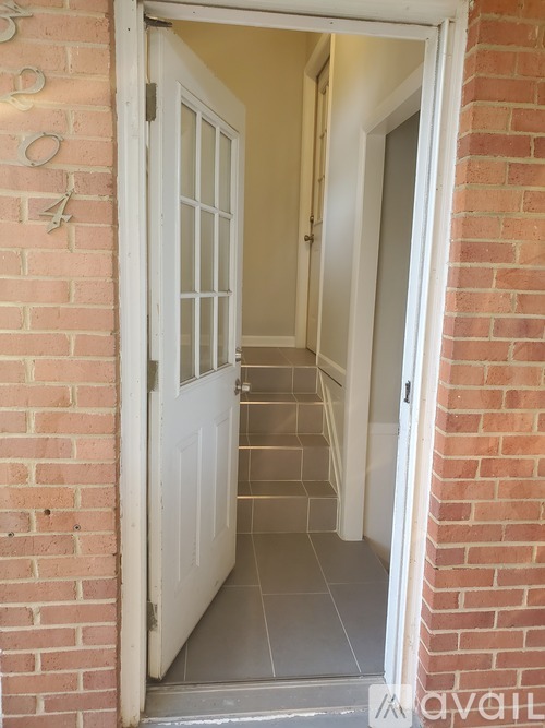 A white door is open to a hallway.