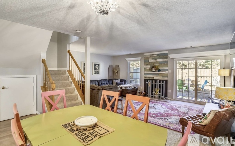 A dining room with a yellow table and chairs.