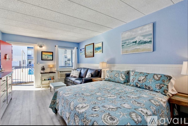 A bedroom with a large bed and a balcony overlooking the city.