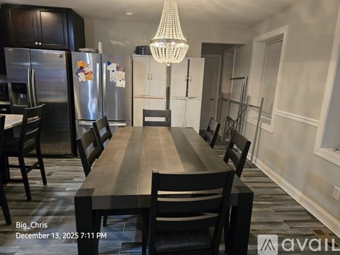 A dining room with a wooden table and chairs.