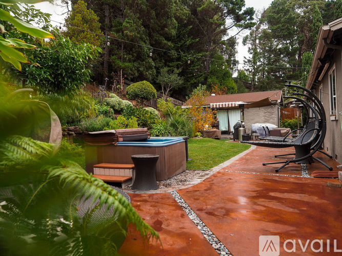 A backyard with a pool table and a chair.