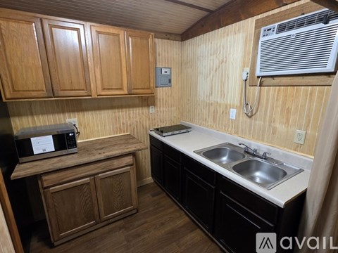 A small bathroom with a toilet, sink, and shower.