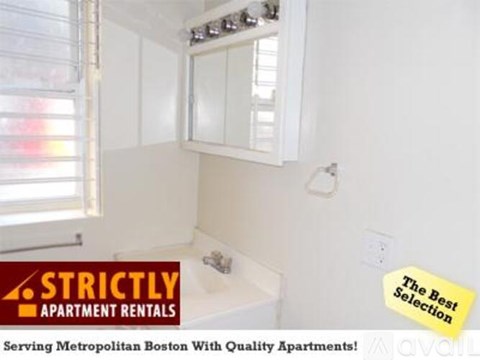 A bathroom with a window and a sink is shown with an advertisement for apartment rentals.