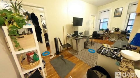 A small room with a white door and a white sink.