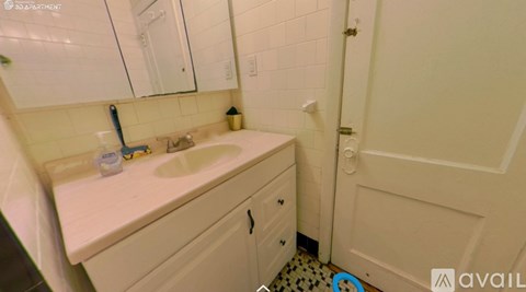A bathroom with a sink, mirror, and toilet.