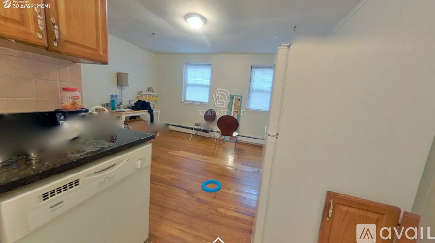 A kitchen with a white oven and wooden cabinets.