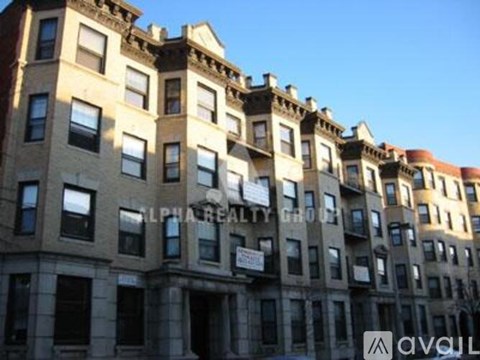 A row of beige and brown buildings with many windows.