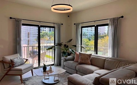 A living room with a couch, chair, and coffee table.