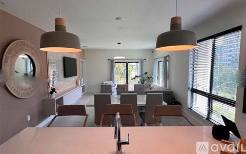 A kitchen with a table and chairs in front of a window.
