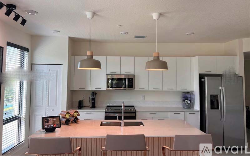 A kitchen with white cabinets and a center island.