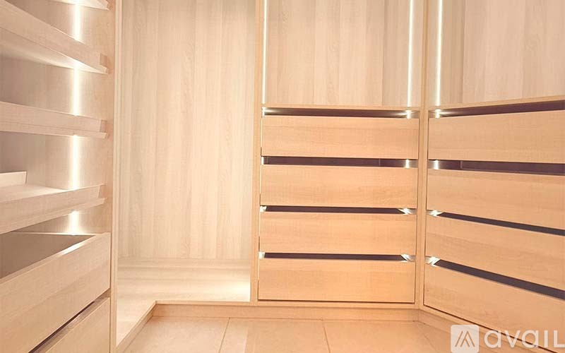 A wooden bathroom with a door and a mirror.