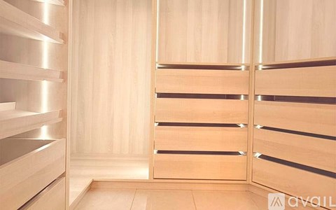 A wooden bathroom with a door and a mirror.