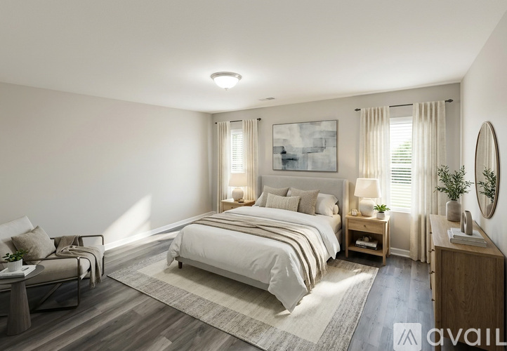 A well-lit bedroom with a large bed and a couch.
