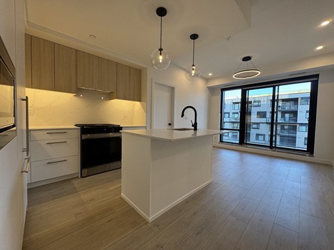 A modern kitchen with wooden cabinets and a large island.