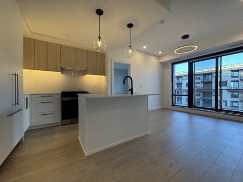 A kitchen with a white counter and wooden cabinets.