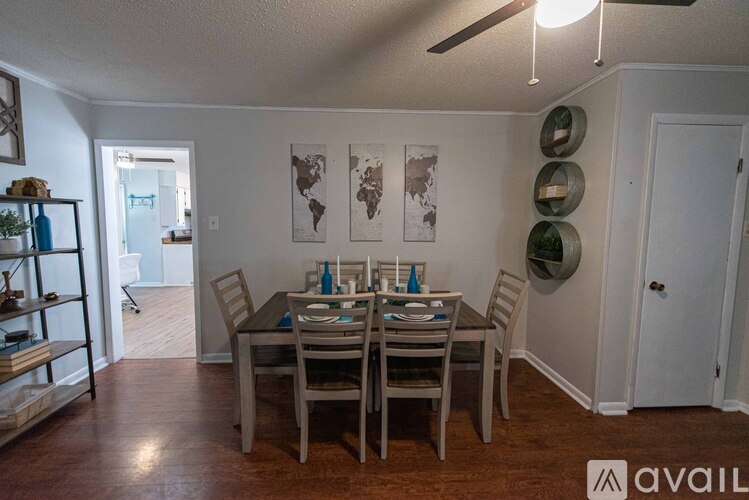 A dining room with a table set for six.