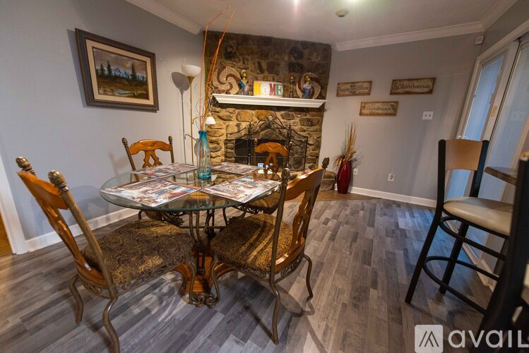A dining room with a glass table and chairs.