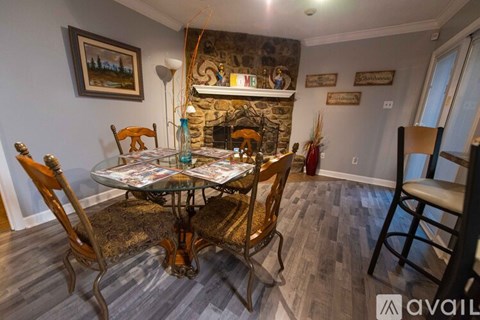 A dining room with a glass table and chairs.