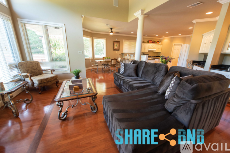 A living room with a brown sofa and a coffee table.