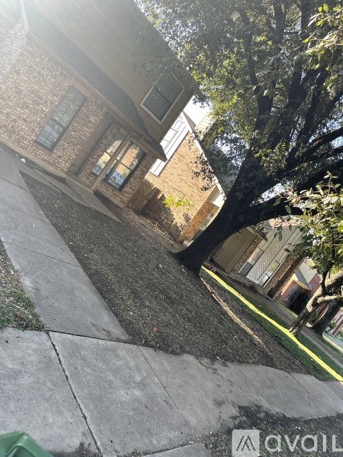 A tree in front of a house.