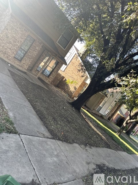 A tree in front of a house.