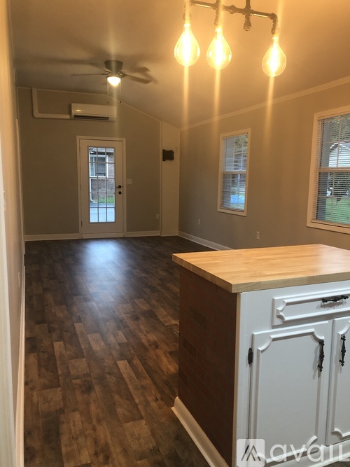 A room with a wooden floor and a white cabinet.