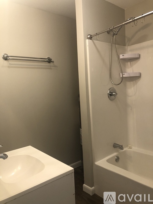 A white sink and bathtub in a bathroom.
