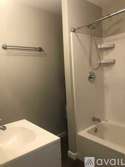 A white sink and bathtub in a bathroom.