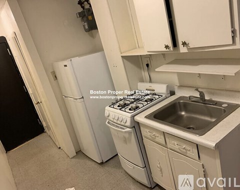 A small kitchen with a stove, oven, and sink.
