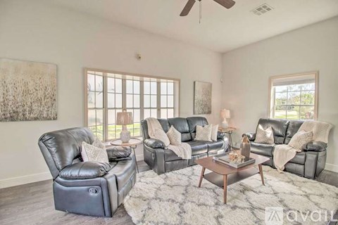 A living room with a grey sofa set and a coffee table.