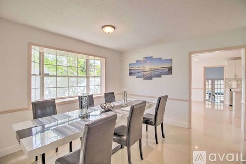 A dining room with a glass table and chairs.